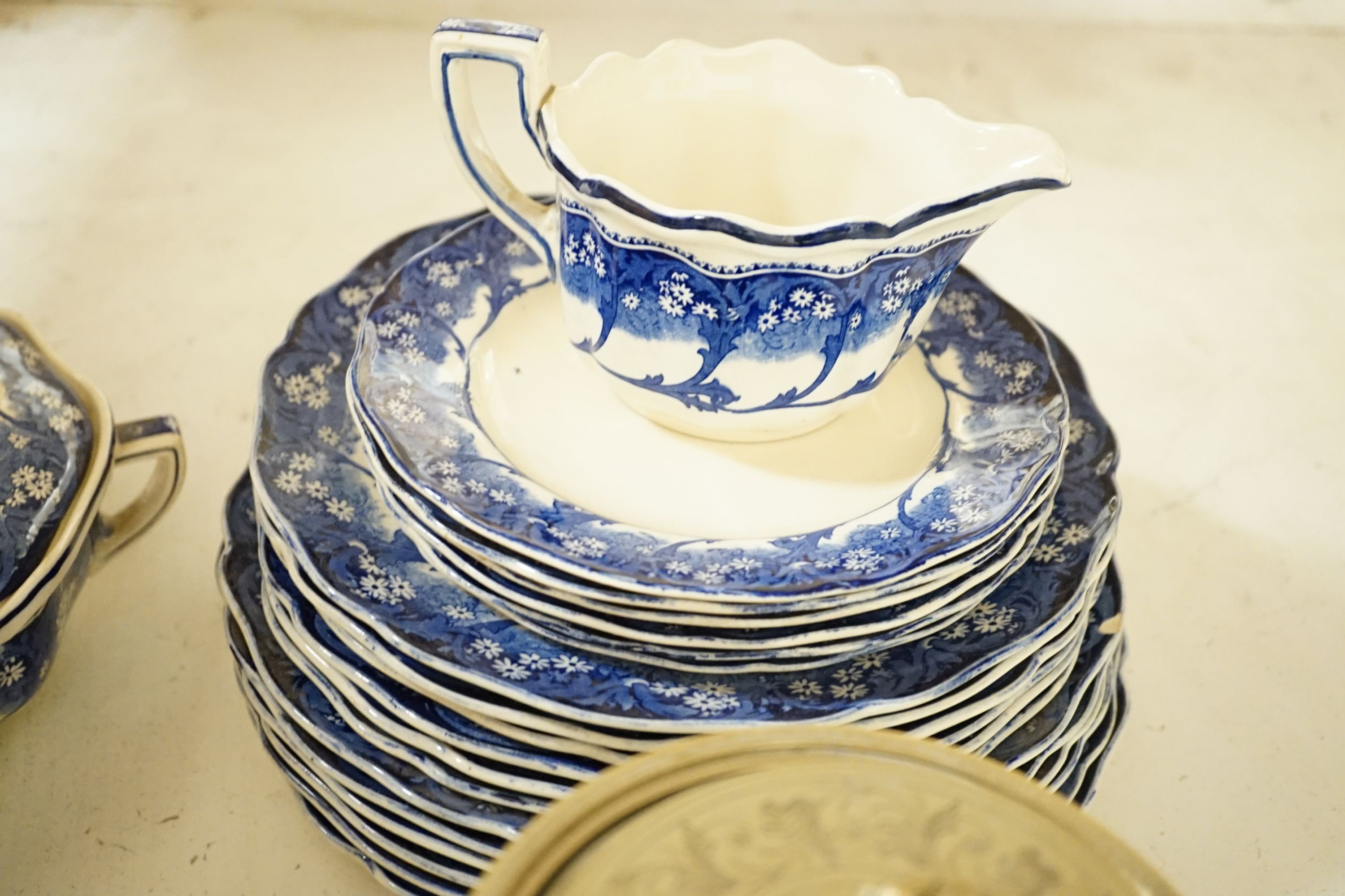 A Royal Doulton ‘Marjorie’ blue and white part dinner service and a Victorian jasper ware and electroplate mounted biscuit box, biscuit box, 17 cms high.